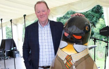 Gerard Eadie photographed with 6ft penguin sculpture by Janice Aitken