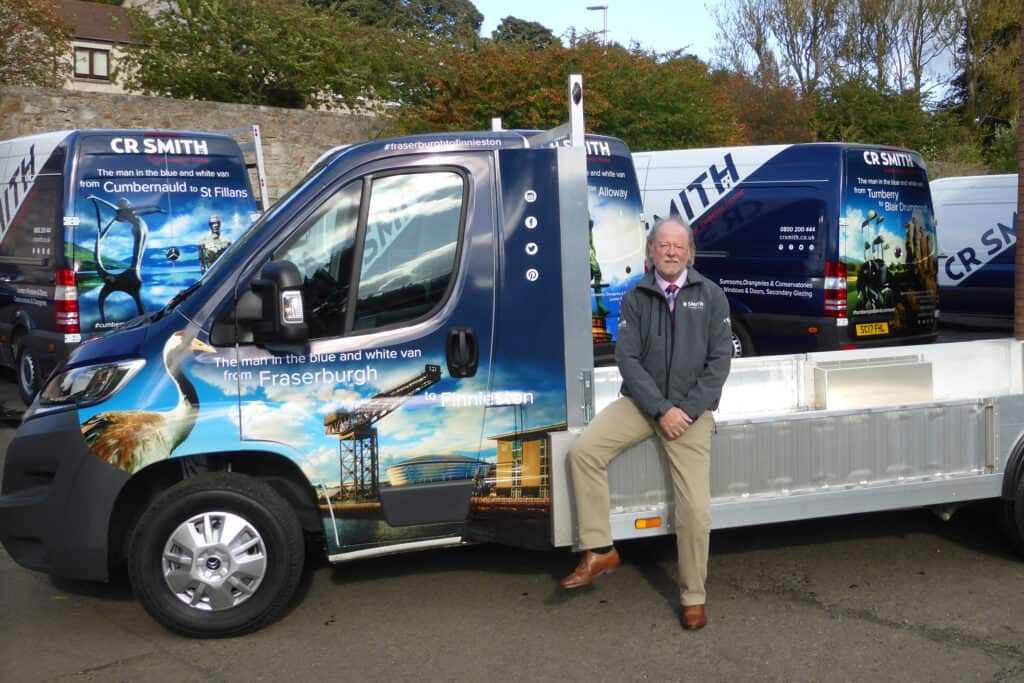 CR Smith Operations Director Hugh Eadie photographed with fleet of vans and tipper truck