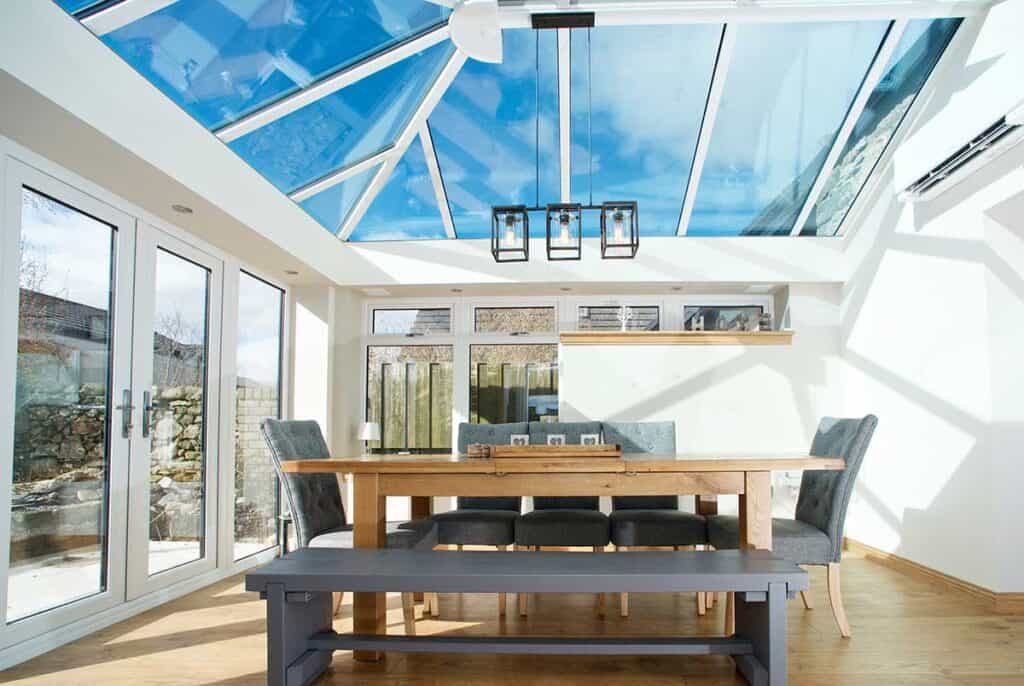 Lorimer orangerie styled as a dining room with blue tinted smart glass and french doors