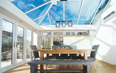 Lorimer orangerie styled as a dining room with blue tinted smart glass and french doors