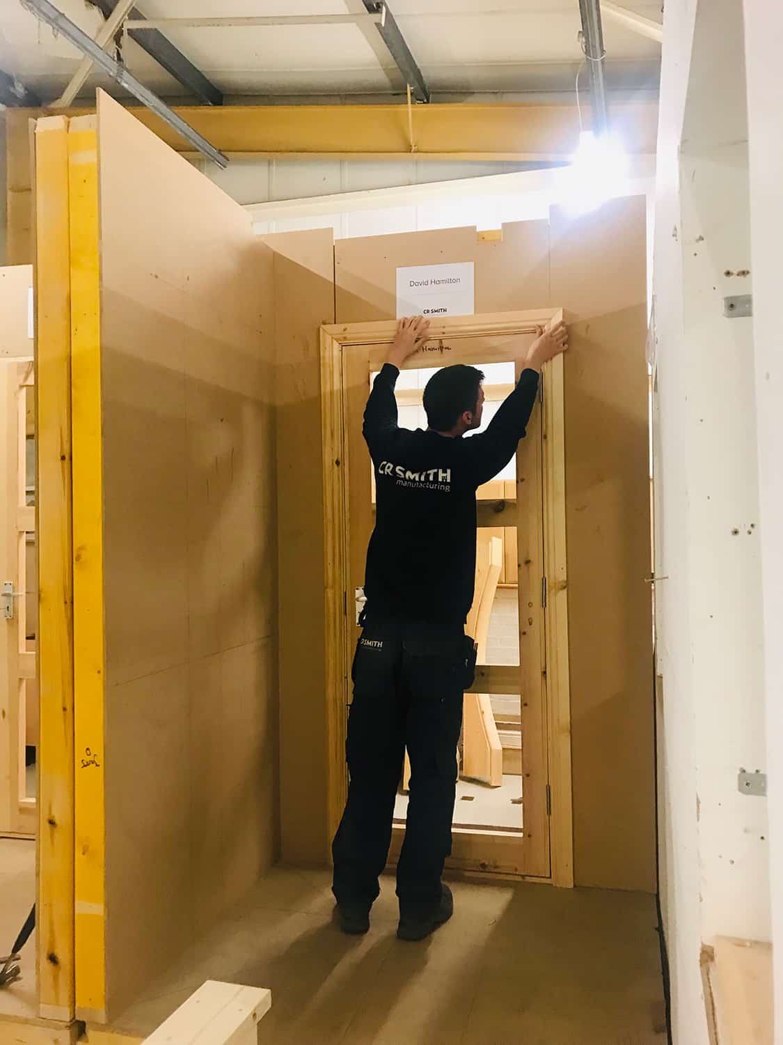 CR Smith employee fitting doorframe