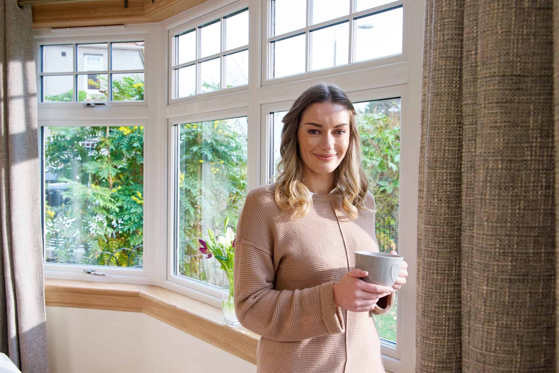 Living room bay window scene with model. Casement windows with royal oak sills and surrounds.