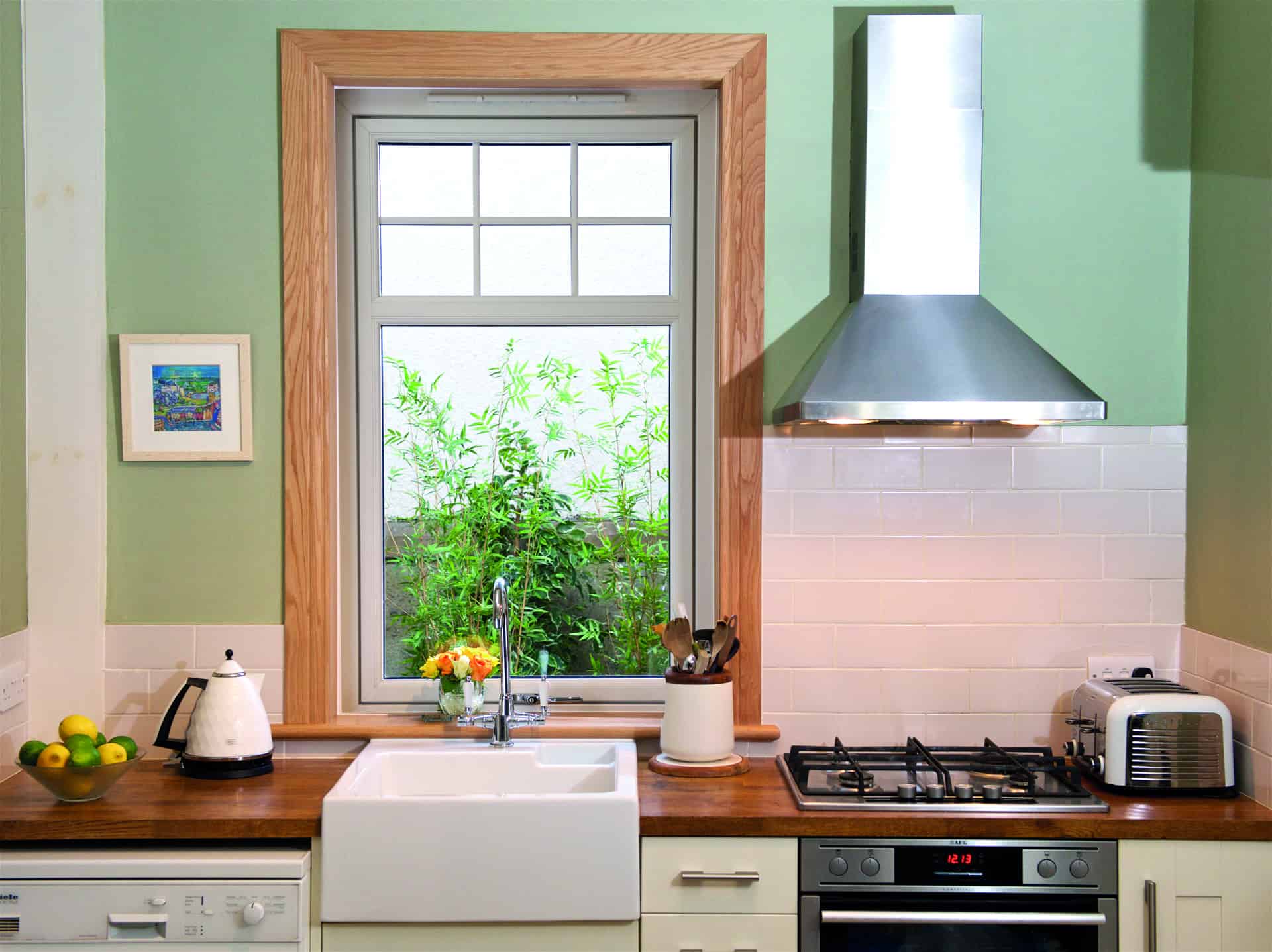 Kitchen with large reversible window behind the kitchen sink with royal oak timber sills and surrounds