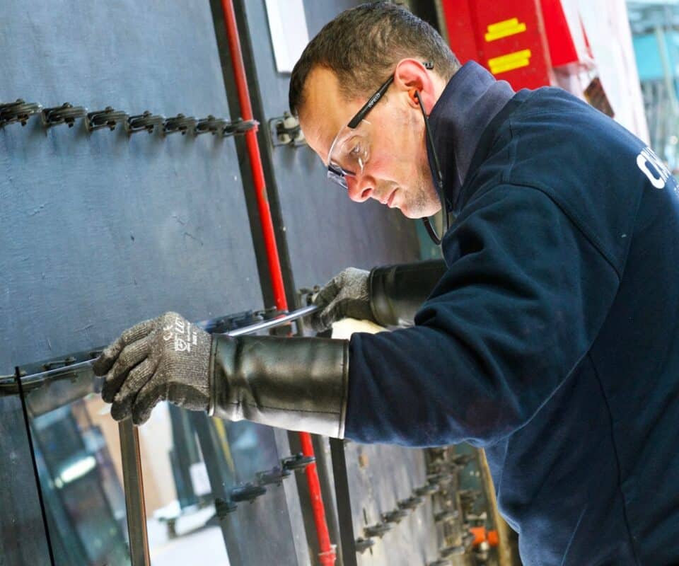 CR Smith member of staff making a glazed unit at the manufacturing plant