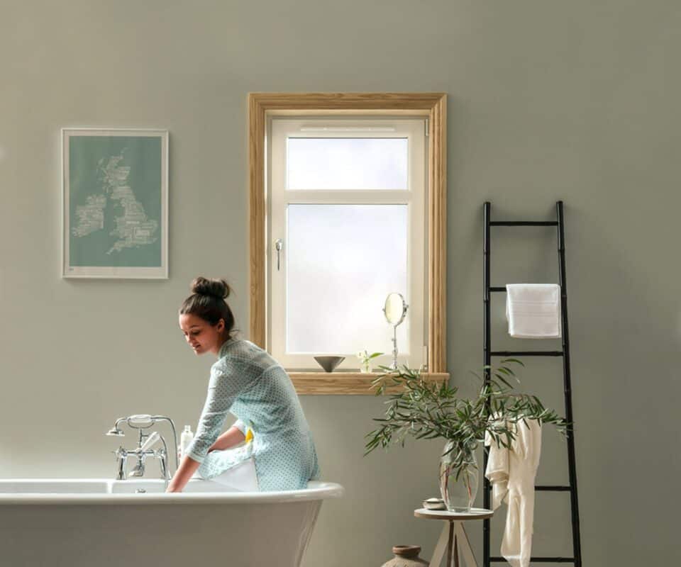 Bathroom scene with model and tilt and turn windows with ash full finish