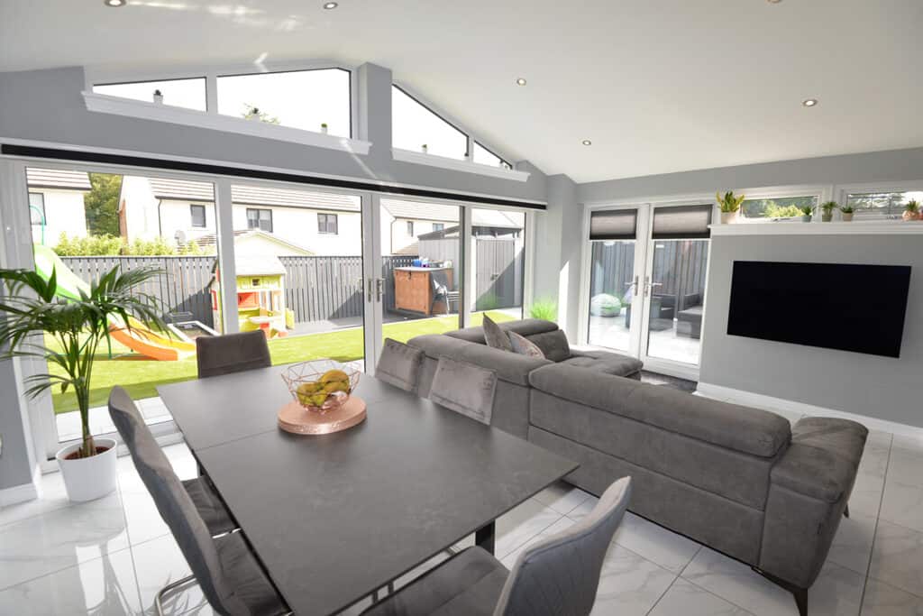 Internal view of Lorimer open plan sunroom with fully vaulted ceiling and large sliding patio doors out to the garden