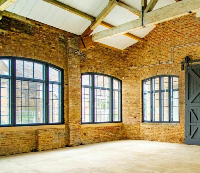 arched windows in a barn fitted with secondary glazing
