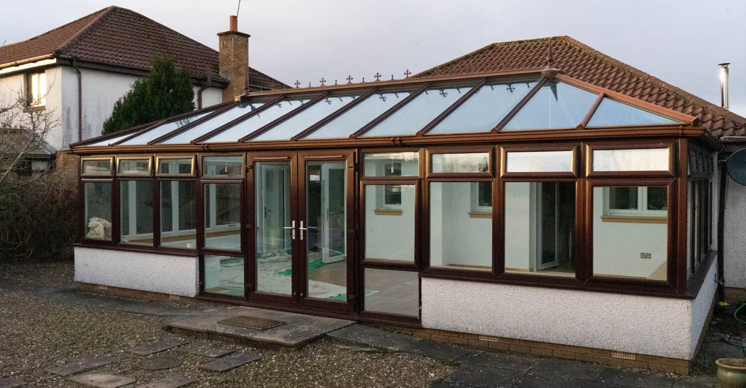 before photo of conservatory with a glass roof before being replaced with a solid roof