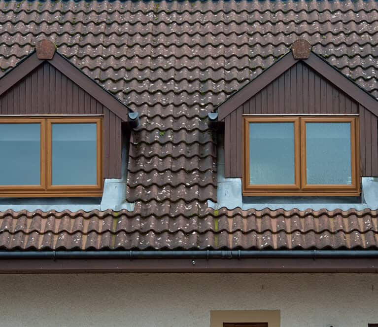 Exterior view of two lorimer casement windows with oak finish.