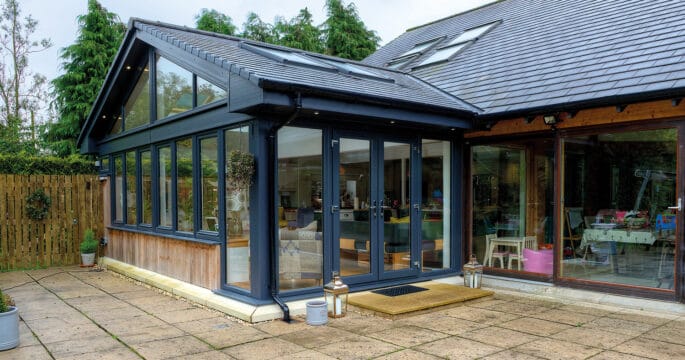 External view of anthracite grey tiled sunroom with french doors