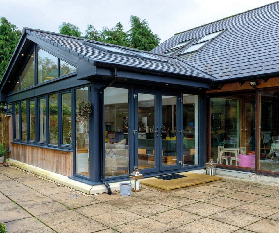 External view of anthracite grey tiled sunroom with french doors