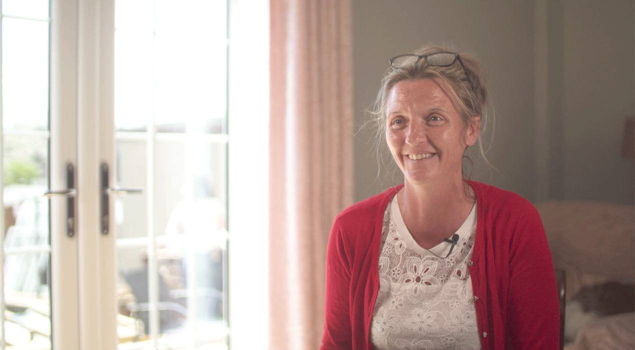 CR Smith customer smiling in front of her new french doors