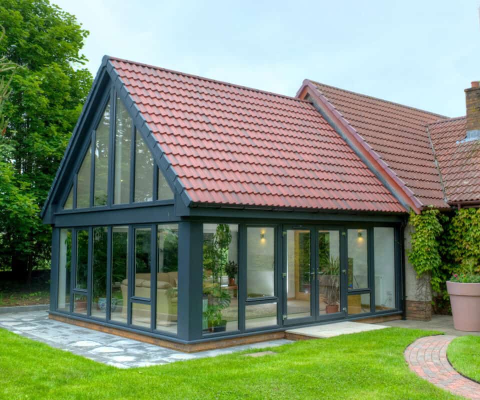 Large anthracite grey sunroom with tiled roof