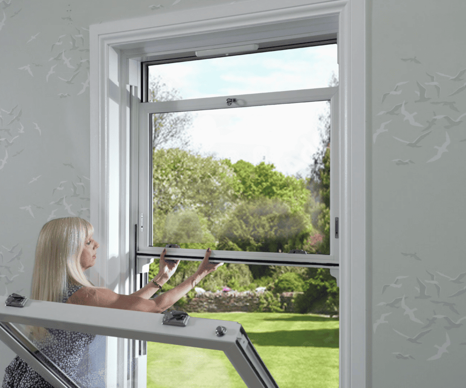 Model demonstrating how to pull down the top sash in a sliding sash window