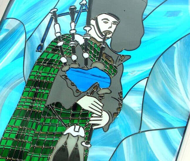 Close up of a stained glass window design of a Scottish piper