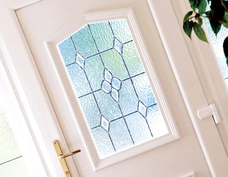 Internal closeup image of decorative glass panel in a white uPVC door