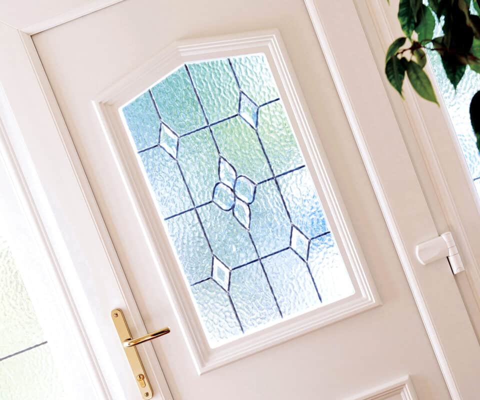 Internal closeup image of decorative glass panel in a white uPVC door