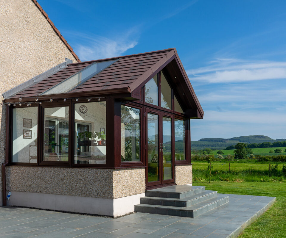 External view of sunroom with new solid roof replacement