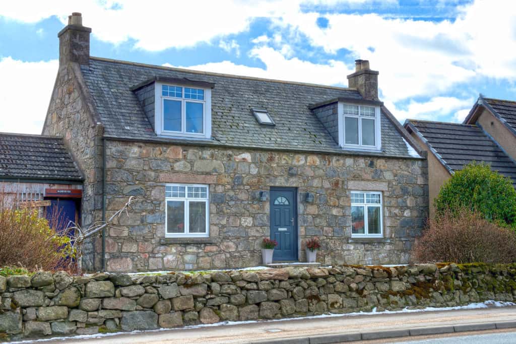 A detached, stone, two storey home located in Elrick, Westhill, in Aberdeenshire. Comprising of white uPVC double-glazed casement windows on ground and first floor.