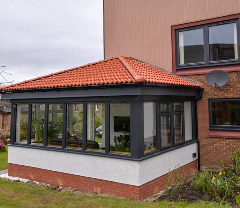 External view of anthracite grey Lorimer sunroom with Edwardian roof design.