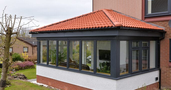 External view of anthracite grey Lorimer sunroom with Edwardian roof design.