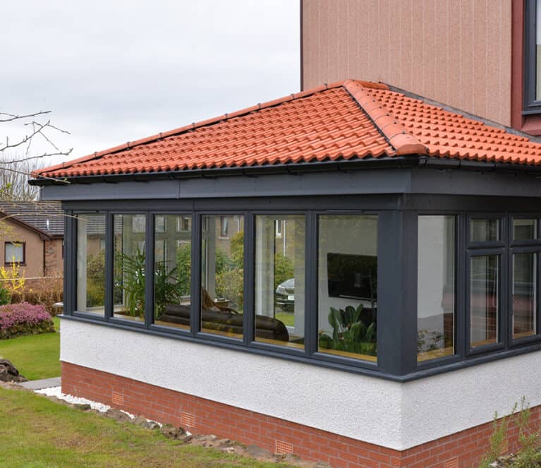 External view of anthracite grey Lorimer sunroom with Edwardian roof design.