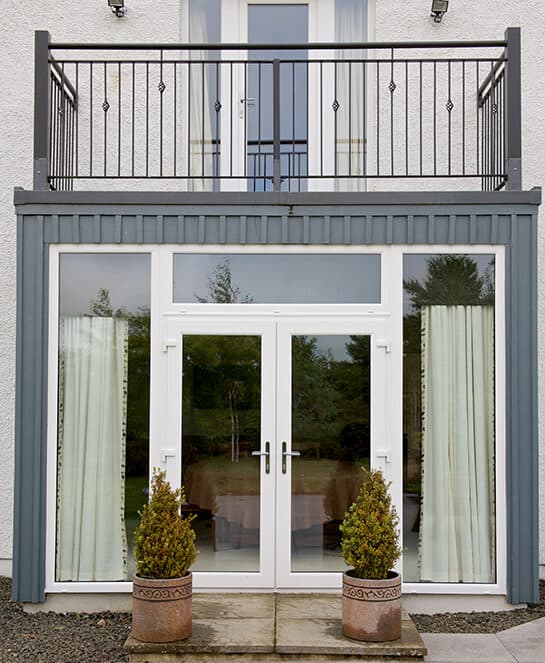 External view of dining room french doors and floor to ceiling picture windows