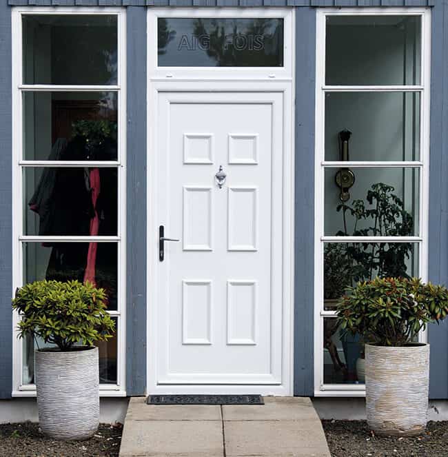 External view of white uPVC front door with chrome urn knocker and lever handle