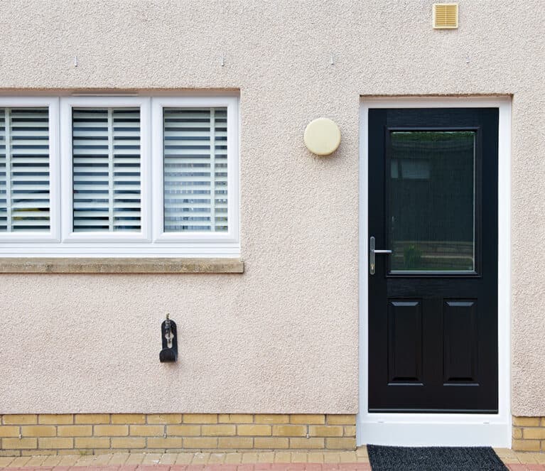 External view of black back door and white kitchen window