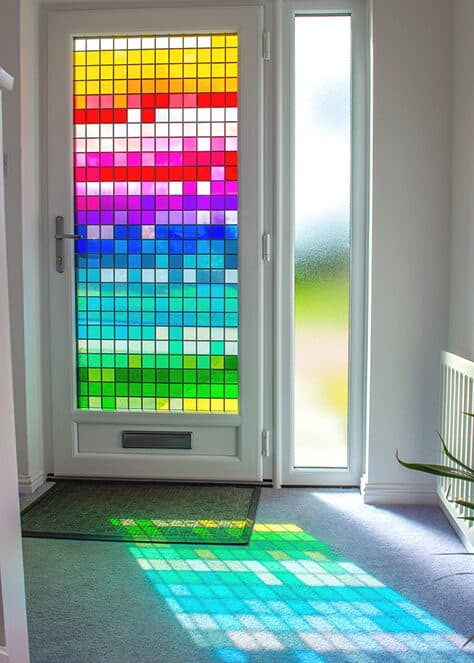 Internal view of the hallway. Multi coloured stained glass design reflects light into the hall.