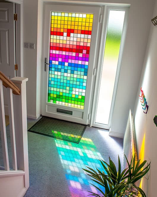 Internal view of the hallway. Multi coloured stained glass design reflects light into the hall.