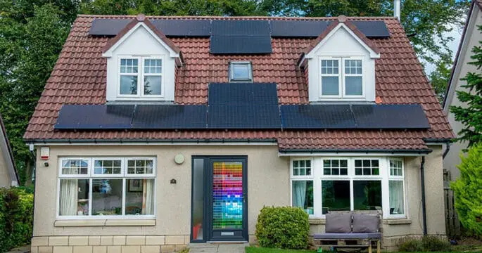 External view of home with anthracite grey front door with a multicoloured stained glass design