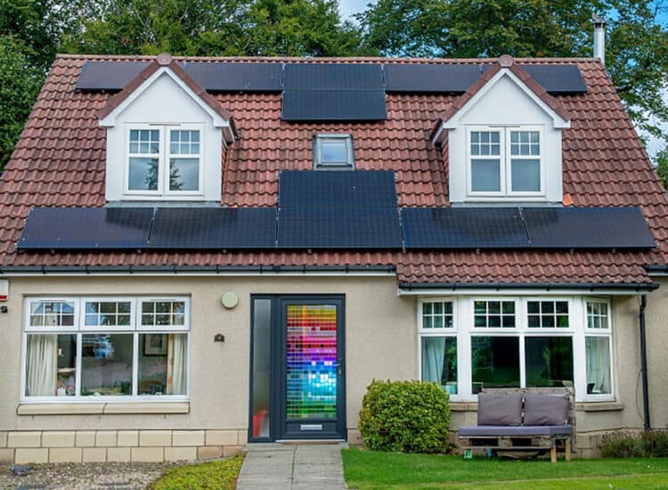 External view of home with anthracite grey front door with a multicoloured stained glass design