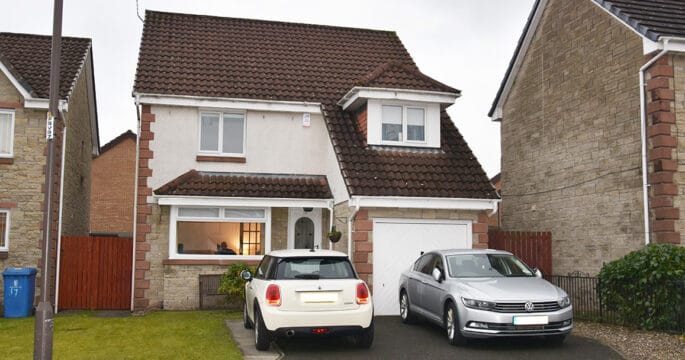 External view of home which has been renovated with white casement windows