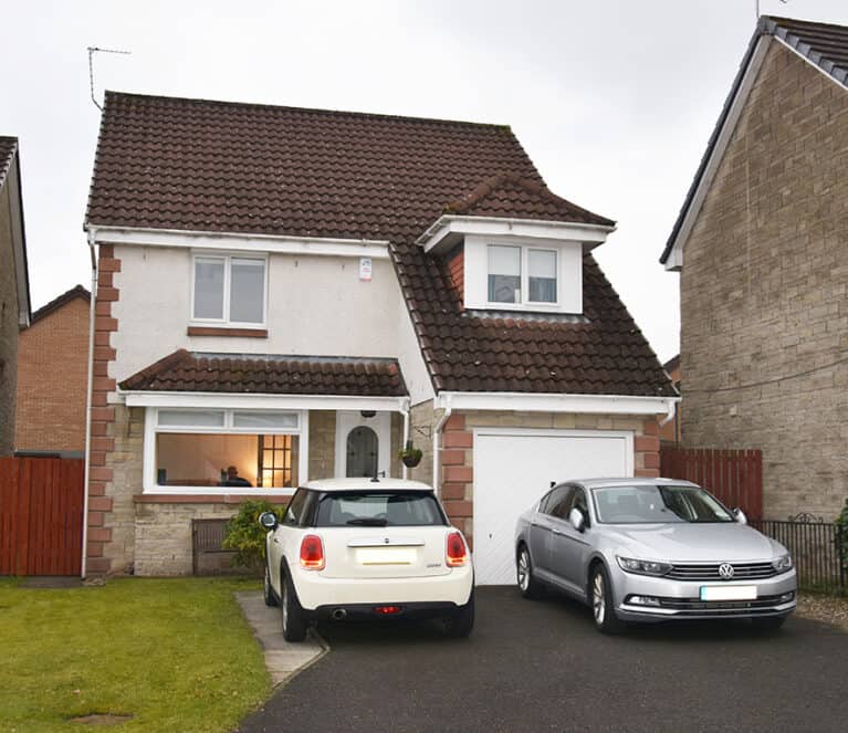 External view of home which has been renovated with white casement windows