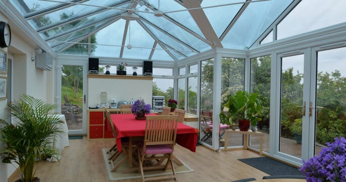 Large white conservatory with smartglass roof and climate control system