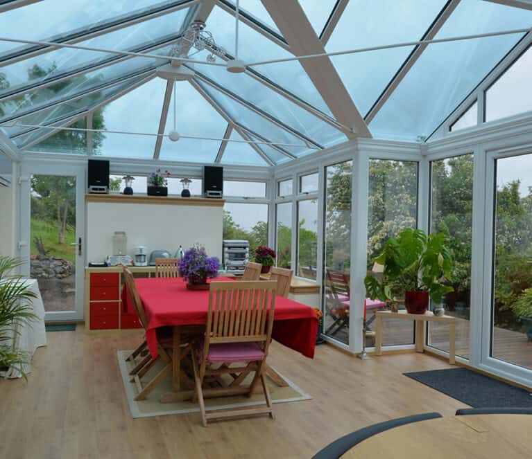 Large white conservatory with smartglass roof and climate control system