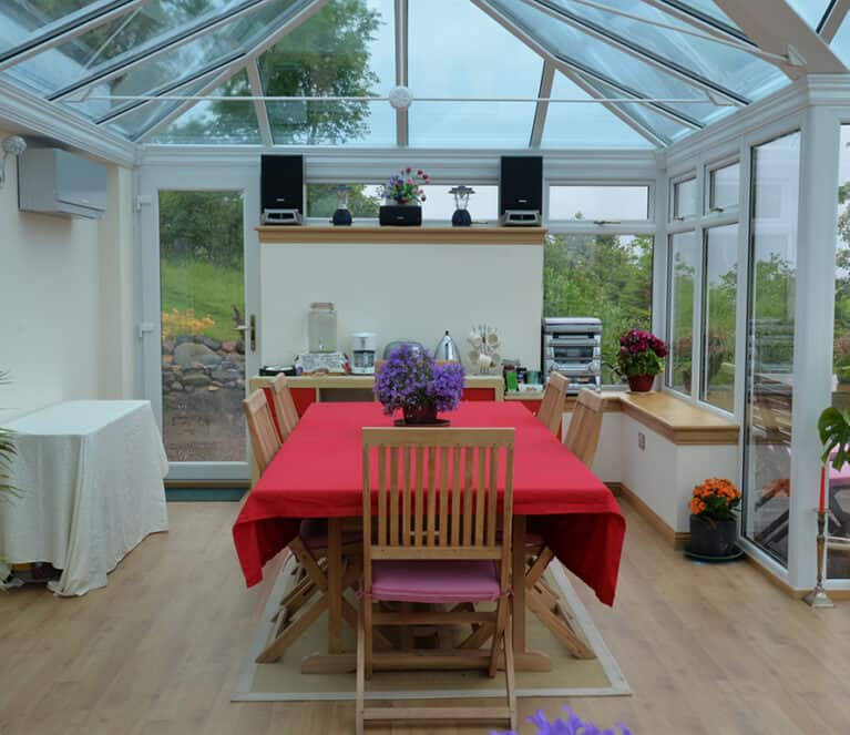 Large white conservatory with smartglass roof and climate control system