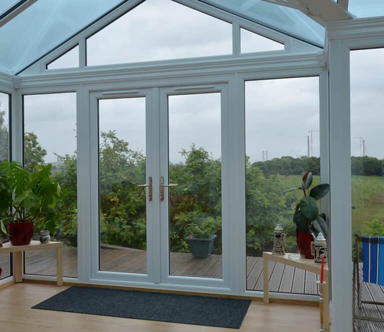 Large white conservatory with smartglass roof and climate control system