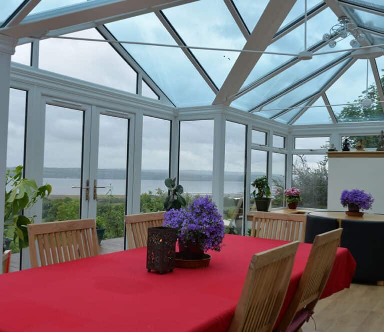 Large white conservatory with smartglass roof and climate control system