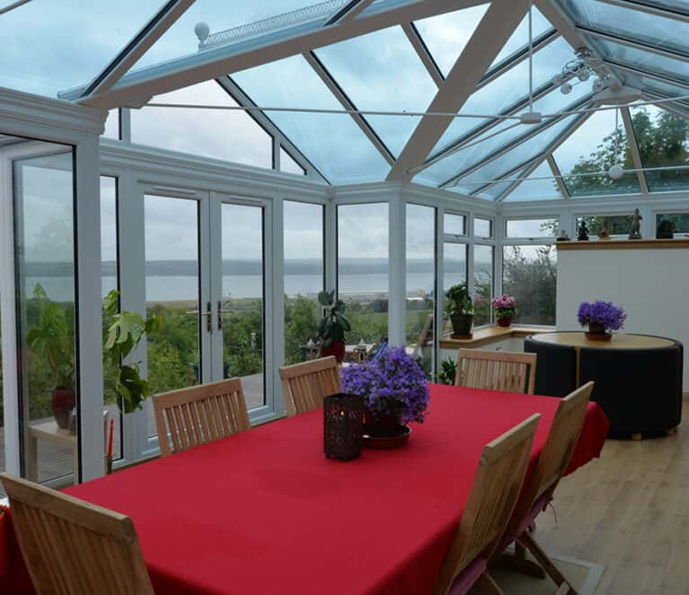 Large white conservatory with smartglass roof and climate control system