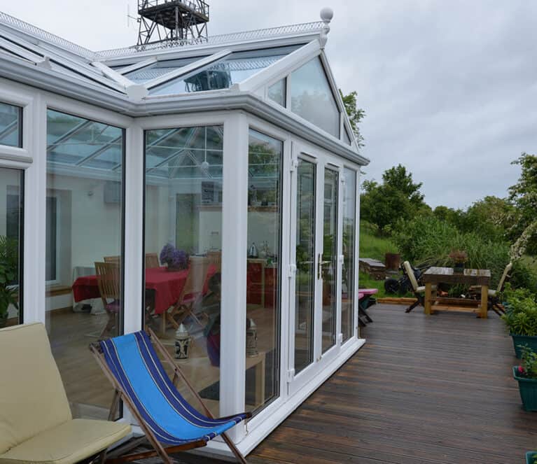 Large white conservatory with smartglass roof and climate control system