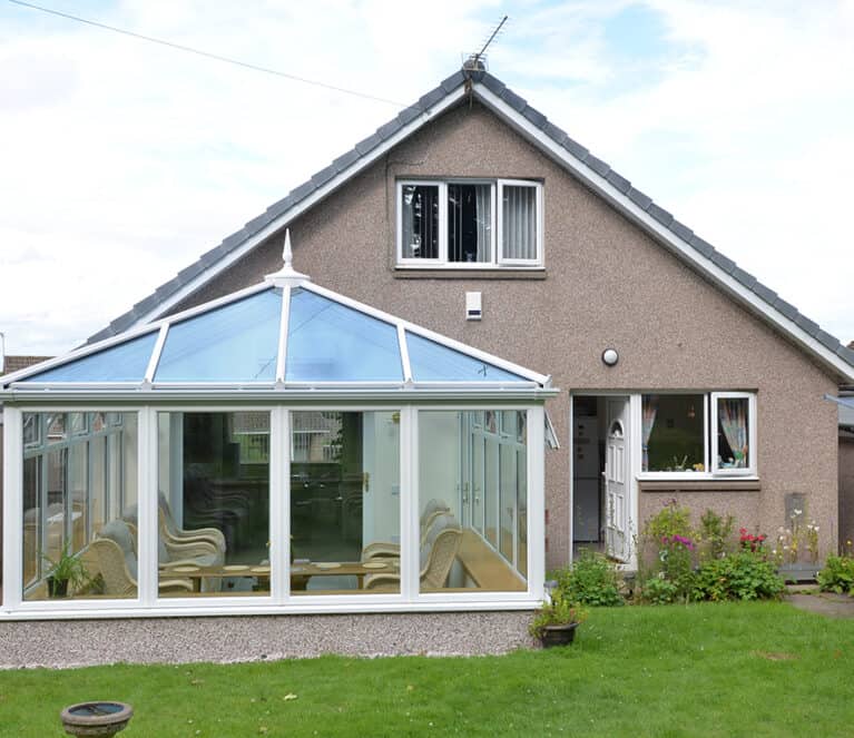 Edwardian shaped white conservatory with blue tinted smartglass roof