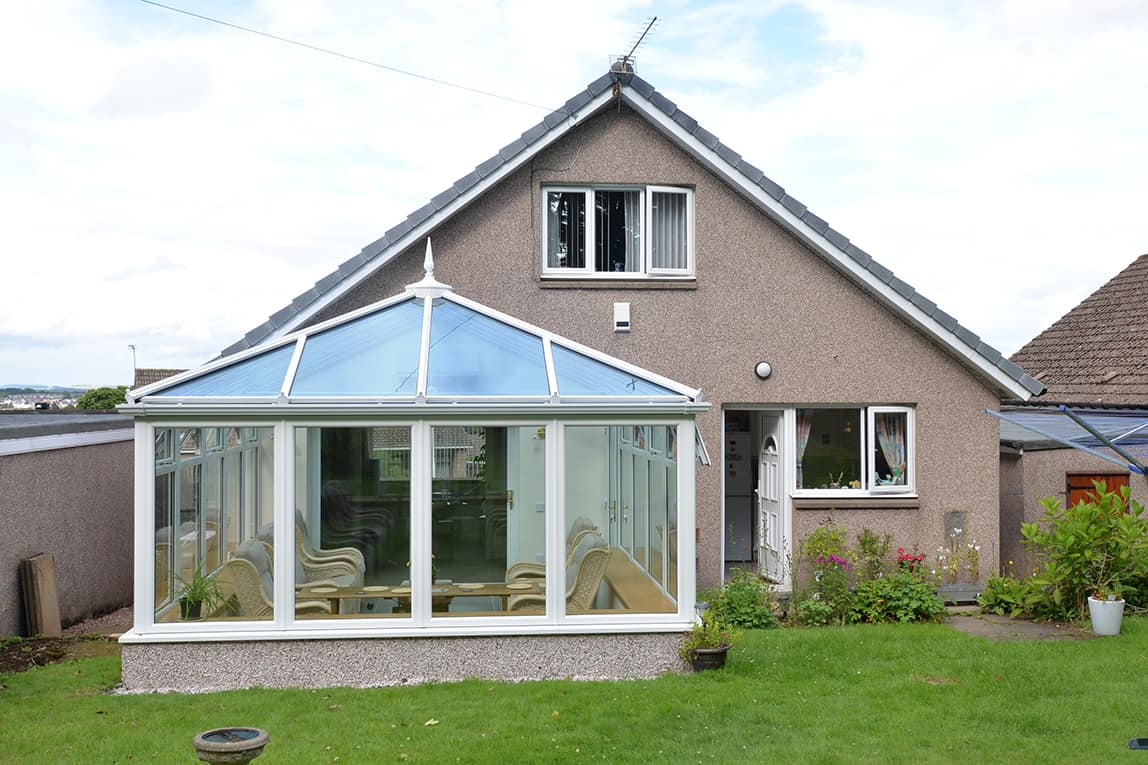 Edwardian shaped white conservatory with blue tinted smartglass roof