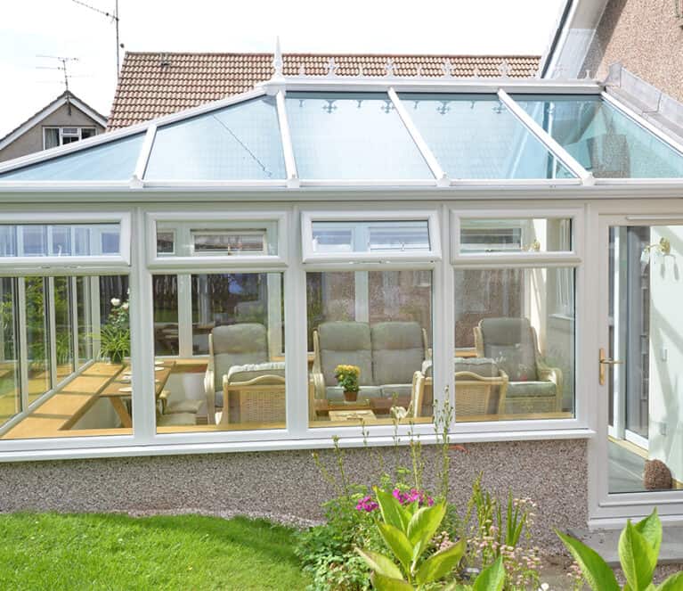 Edwardian shaped white conservatory with blue tinted smartglass roof