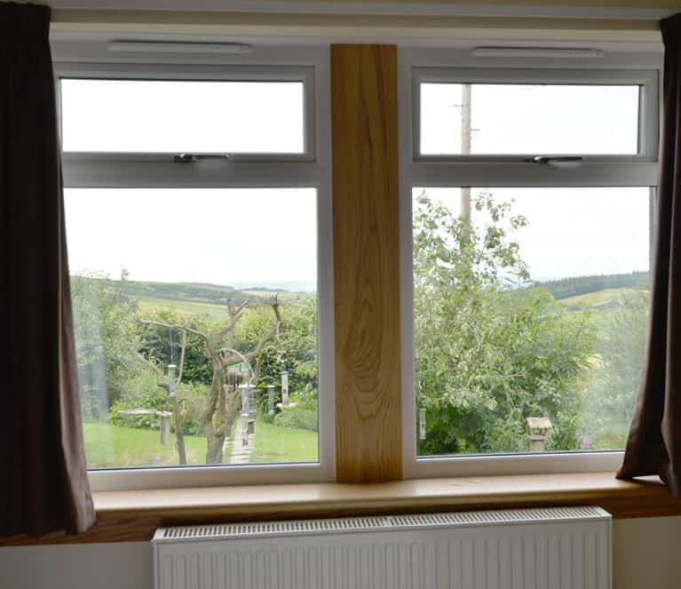 White casement windows with royal oak timber sills