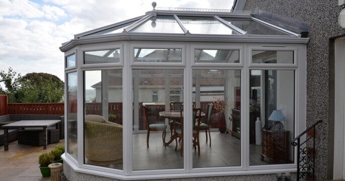 White victorian shaped conservatory with floor to ceiling glazing