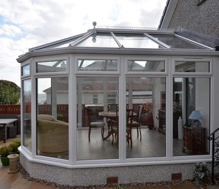 White victorian shaped conservatory with floor to ceiling glazing