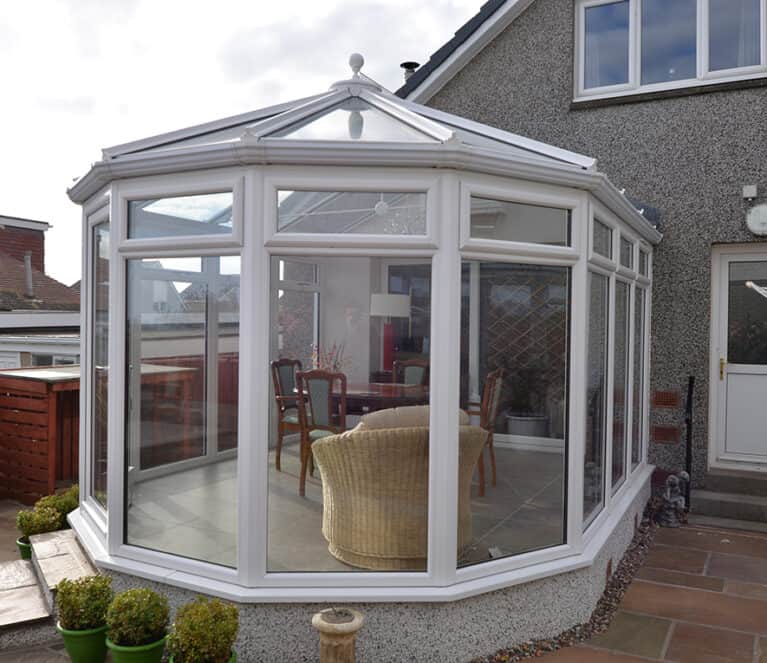White victorian shaped conservatory with floor to ceiling glazing