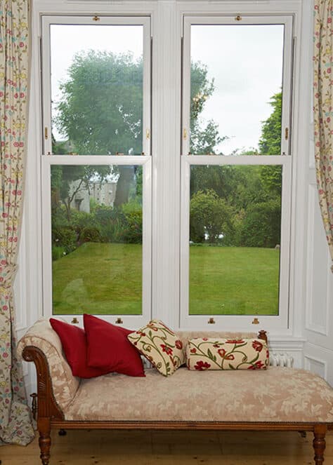 Living room with large white sliding sash windows